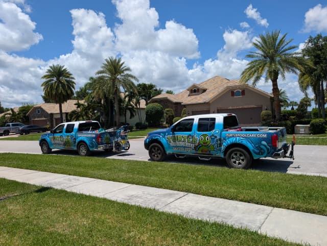 Turtle Pool Care branded service trucks parked on a residential street
