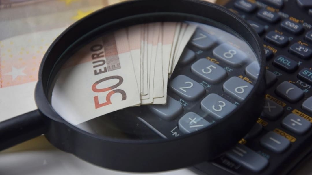 A magnifying glass over a 50-euro banknote