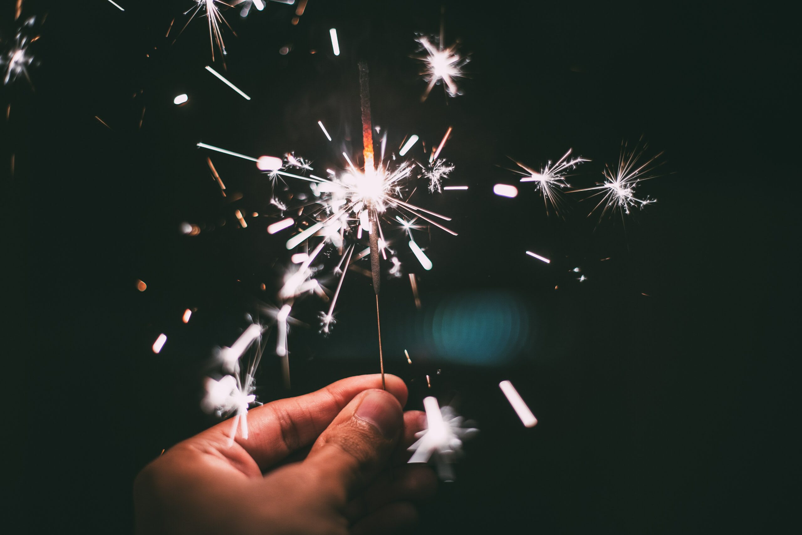 someone holding sparklers on new years eve