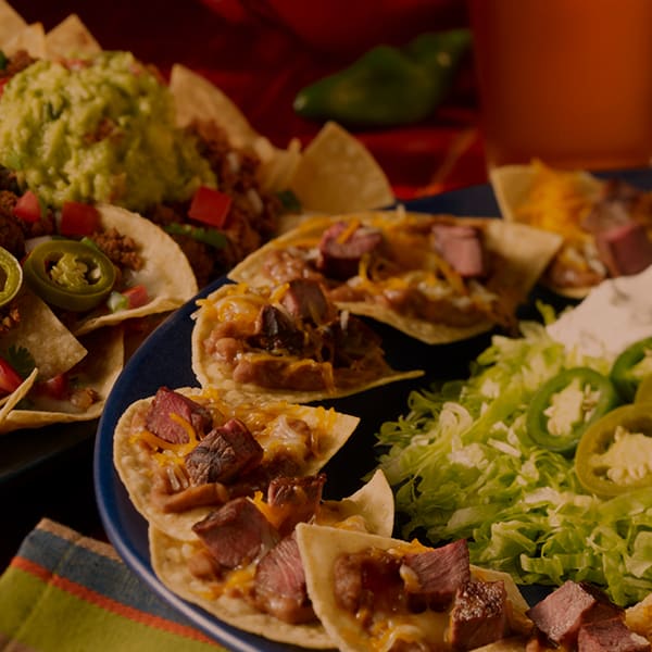 two plates of nachos