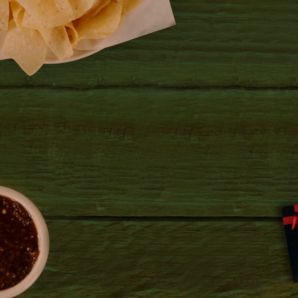 tortilla chips and salsa on table with a gift card