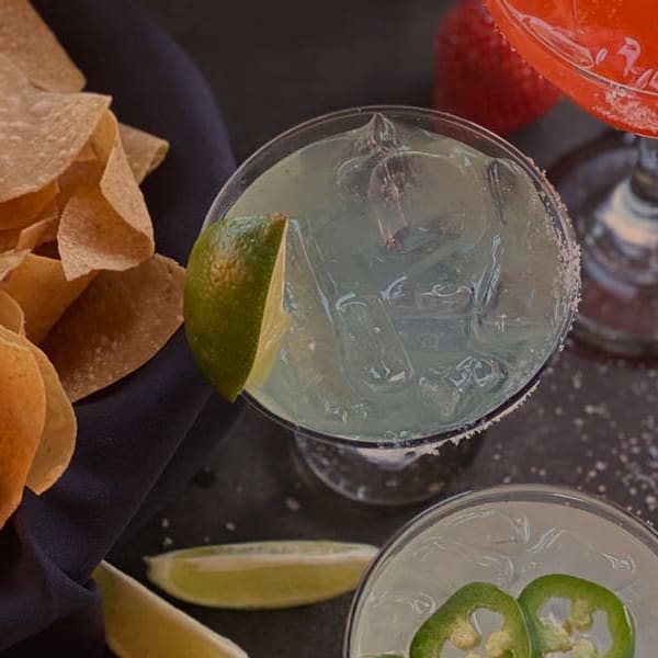 Chips and three margaritas on a table