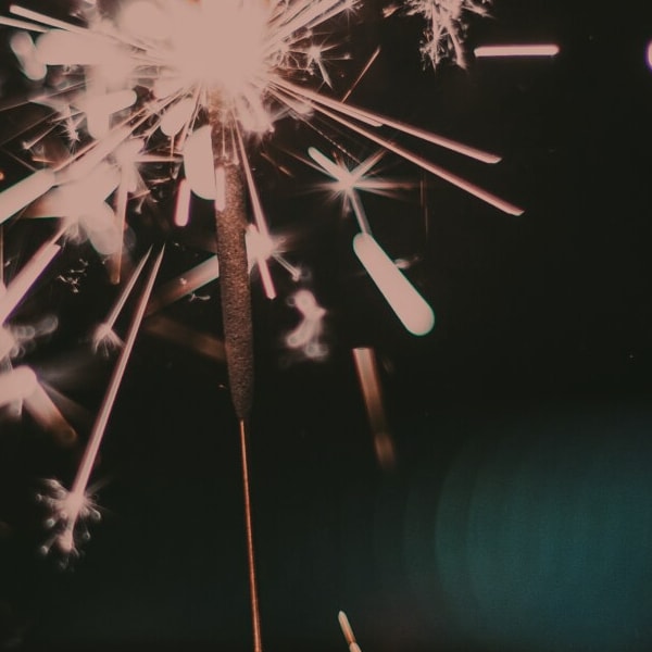 someone holding sparklers on new years eve