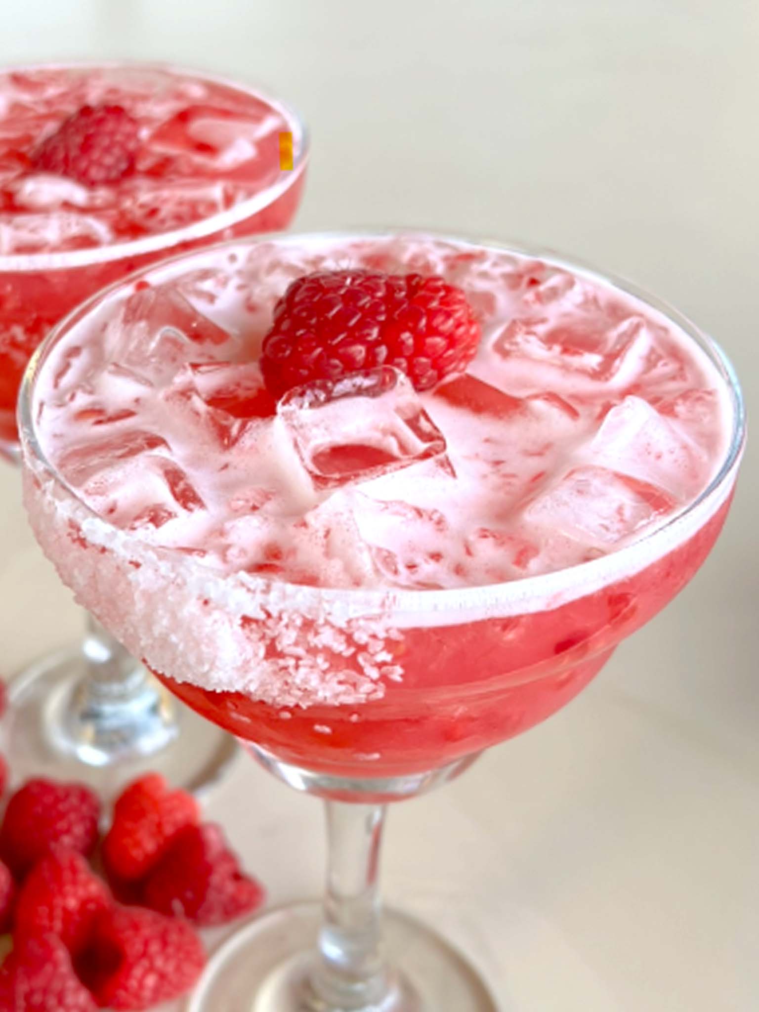 Raspberry margarita garnished with a fresh raspberry