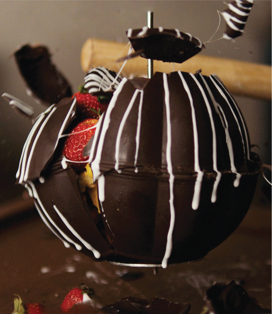 smashed chocolate piñata with fruit coming out of it