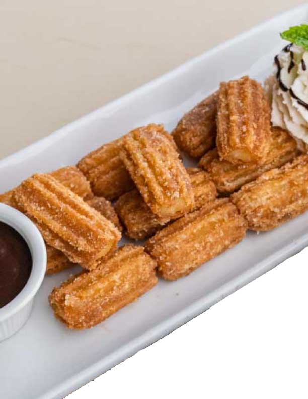 Mini churros served with a side of chocolate sauce