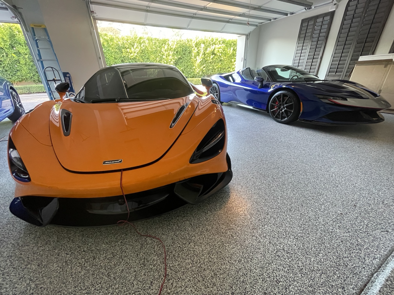 McLaren and Ferrari parked together in a private garage
