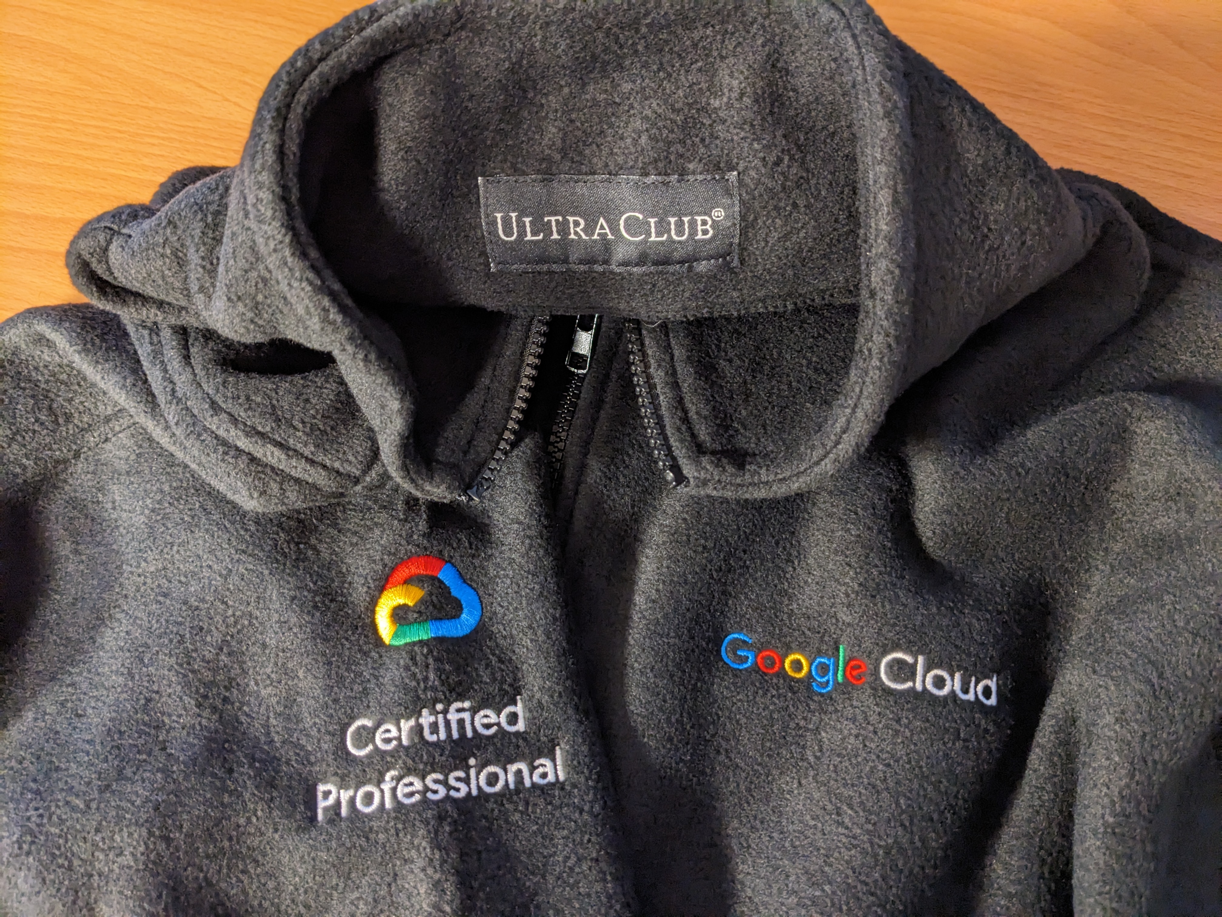 A black "Ultra Club" fleece jacket with the "Google Cloud" and "Certified Professional" logos embroidered on the chest.