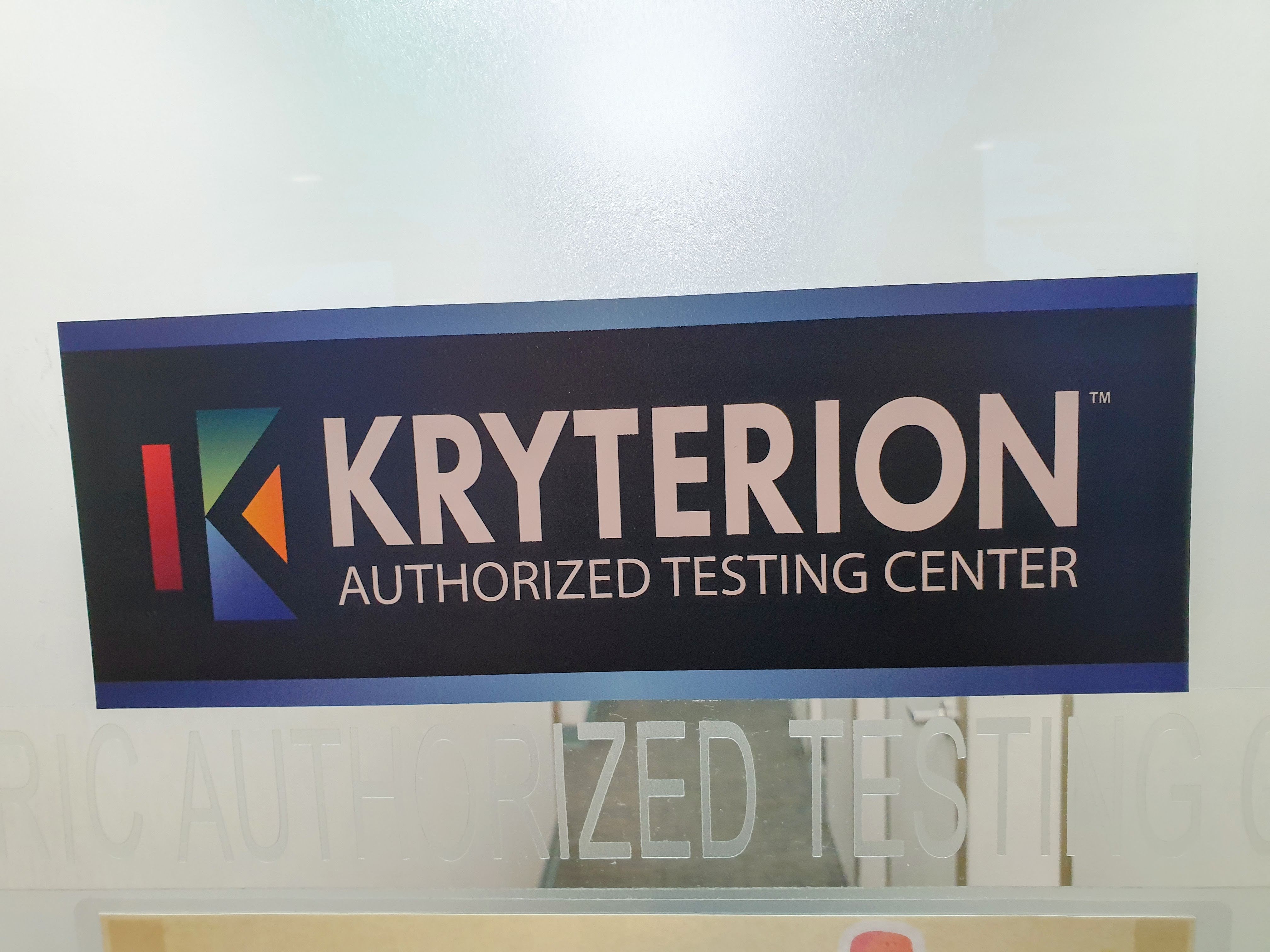 A close-up of a sign on a frosted glass door for the "Kryterion Authorized Testing Center," featuring the Kryterion logo.