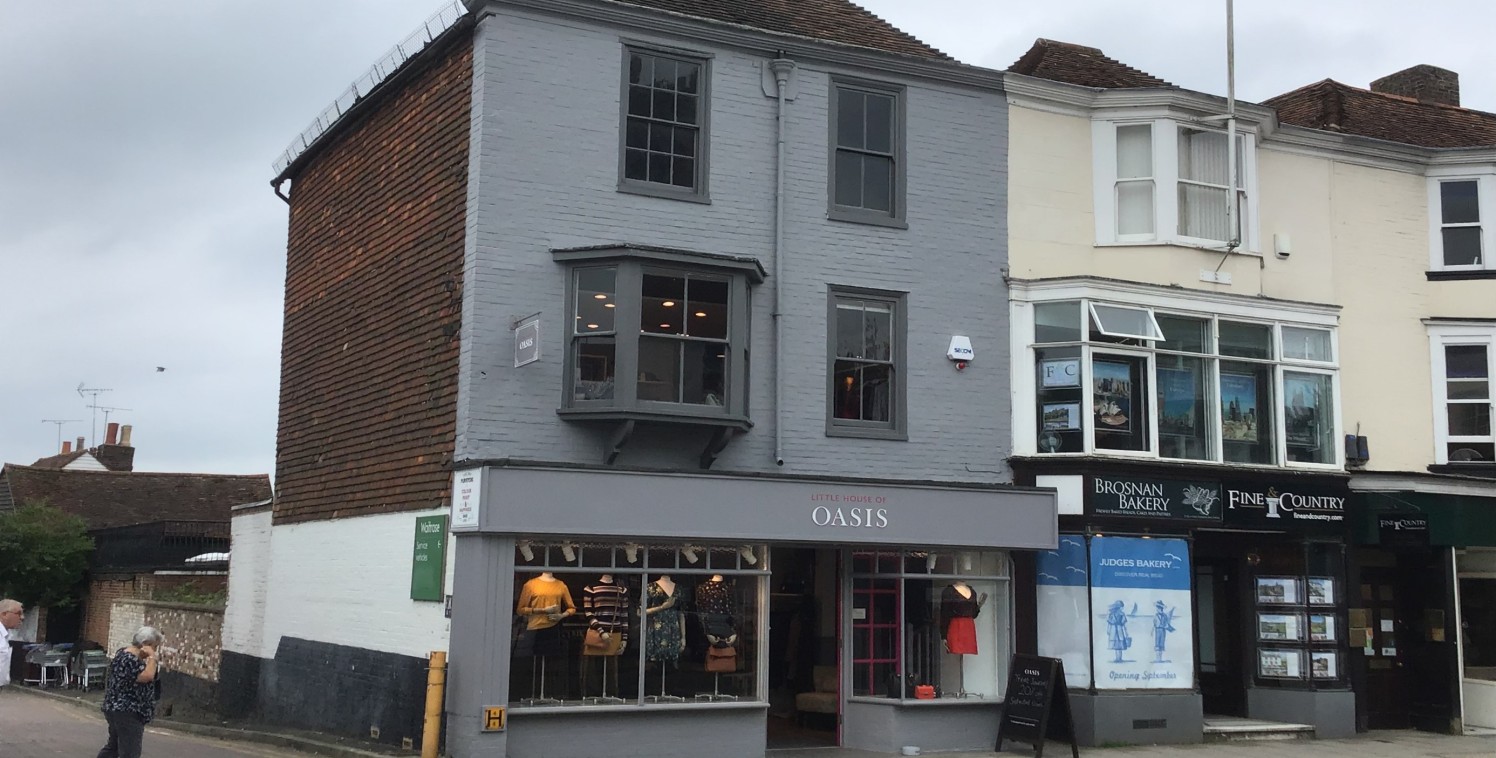 An end of terrace building which is Grade II listed building arranged over ground, first and second floor. The ground and much of the first floor is used for retailing with storage, staff and W.C. on the rest of the first and second floors.