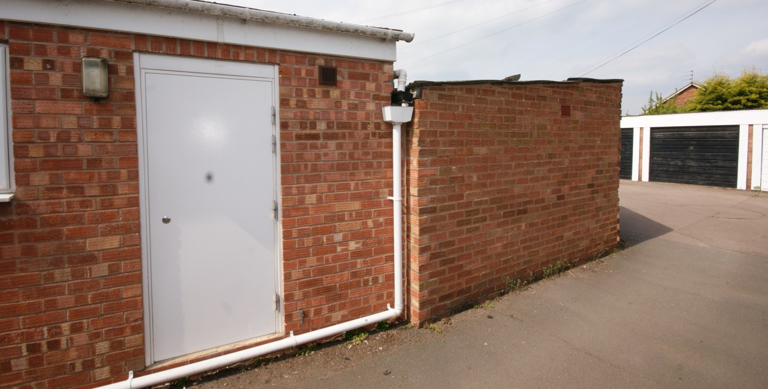 Large Retail Premises, former Pharmacy. Storage within a converted garage at the rear.