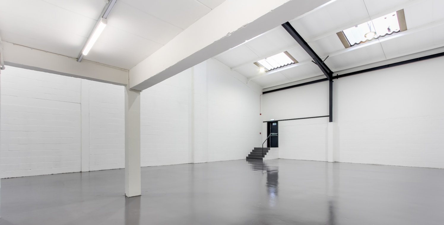 The property comprises a mid-terrace warehouse / industrial unit, built of steel frame construction with half height concrete block elevation under a pitched sheet roof with two-storey offices to the front elevation. Access into the unit is via the s...