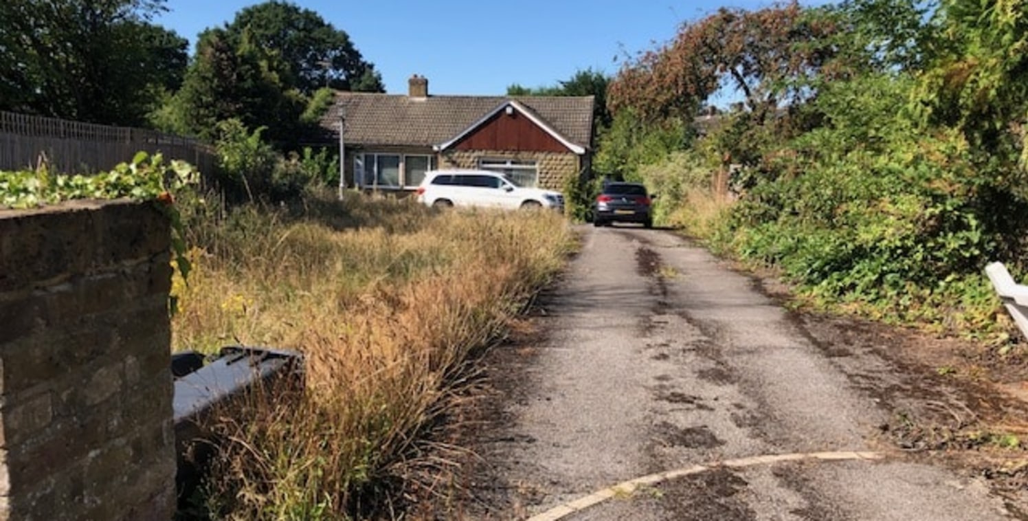 The plot is positioned on Bells Hill directly opposite a bus stop, within walking distance of the village centre which has various amenities such as a pharmacy, Costa Coffee, Co-Op and Doctors Surgery. The plot currently consists of a detached bungal...