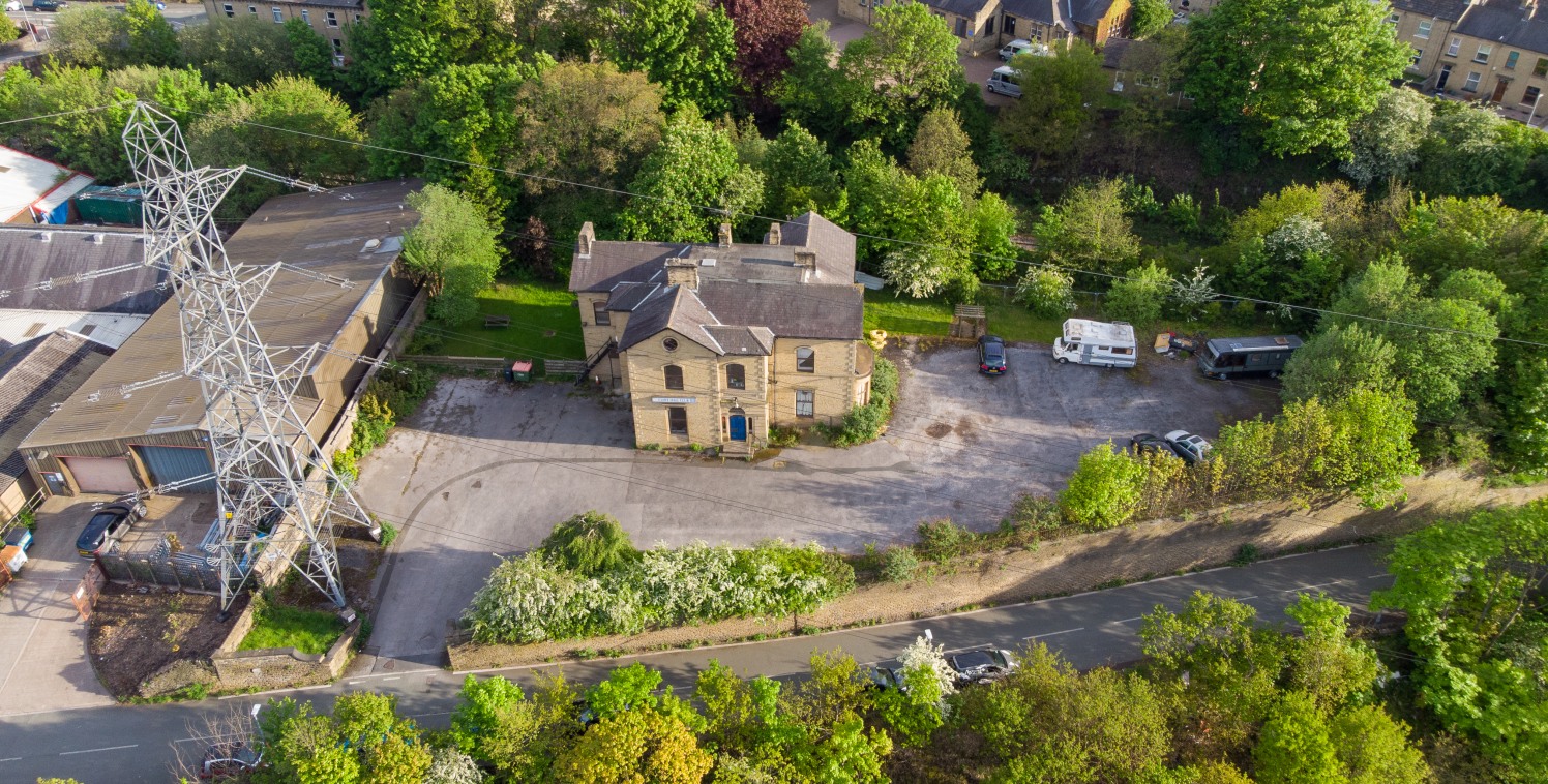 The property comprises a substantial former social club of stone construction under a blue slate multi-pitched roof with a section of flat roof. The property is solely accessed from Cliffe Street and features an extensive hard standing car park and b...