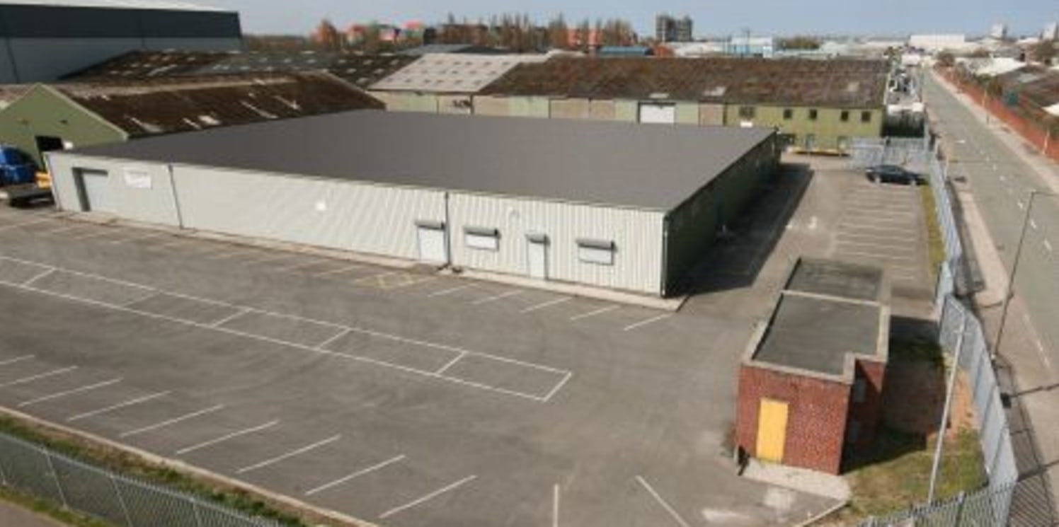Secure fenced site. Profile metal cladding. Extensive car parking / loading areas. Ground level loading doors.