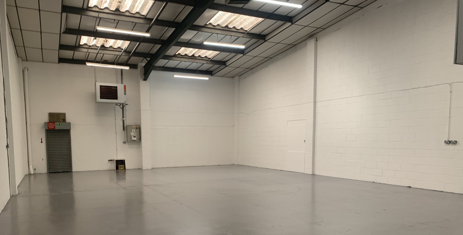 The estate comprises a terrace of single storey industrial units constructed of a steel portal frame with pitched cement sheet roofs and blockwork and profile sheet cladding to the side elevations. Unit 2 is a mid terrace unit and benefits from: