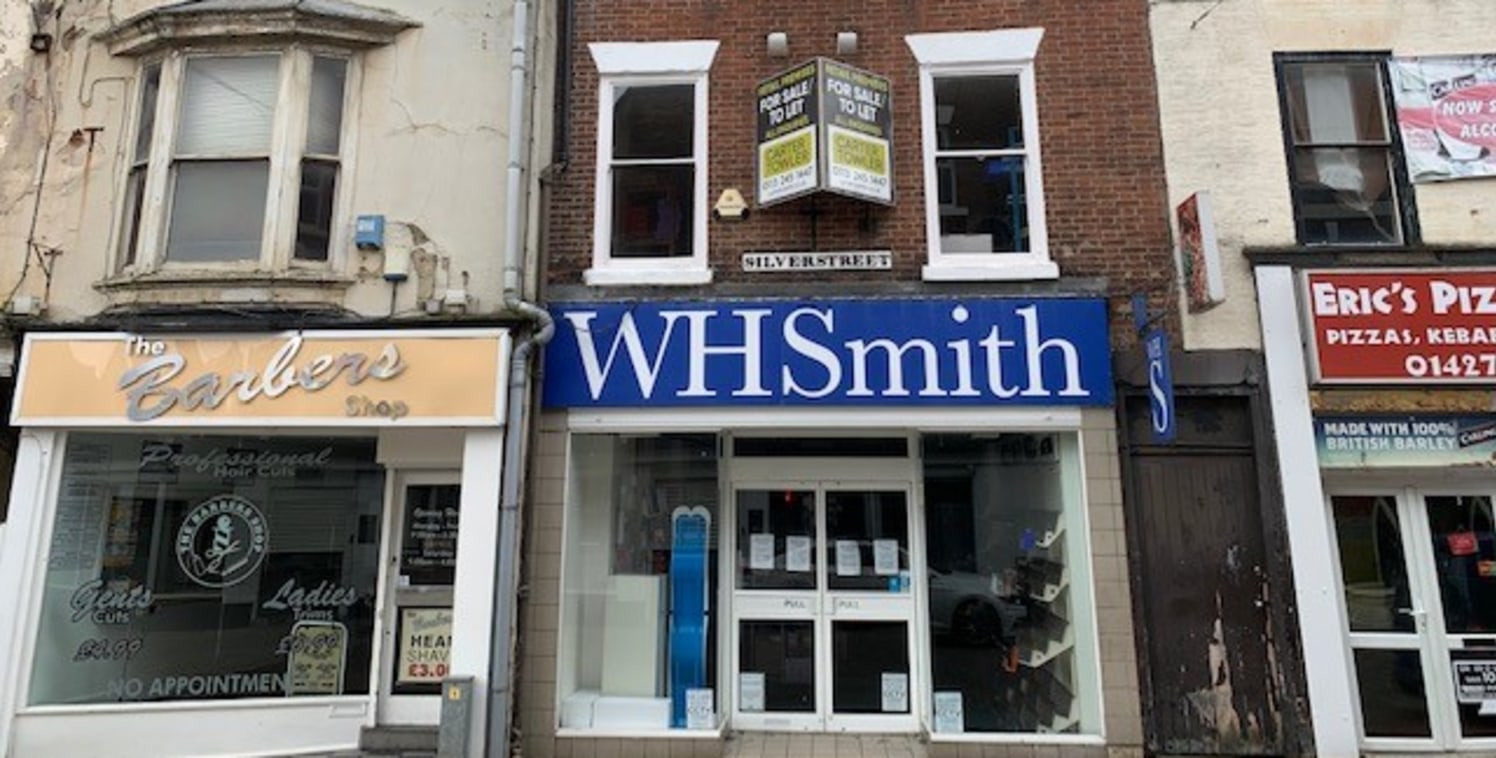 The building comprises a 3 storey Grade II listed brick built retail property set under a pitched slate roof with glazed shop window frontage situated within a parade of shops in Gainsborough town centre. The ground floor comprises a small sales area...