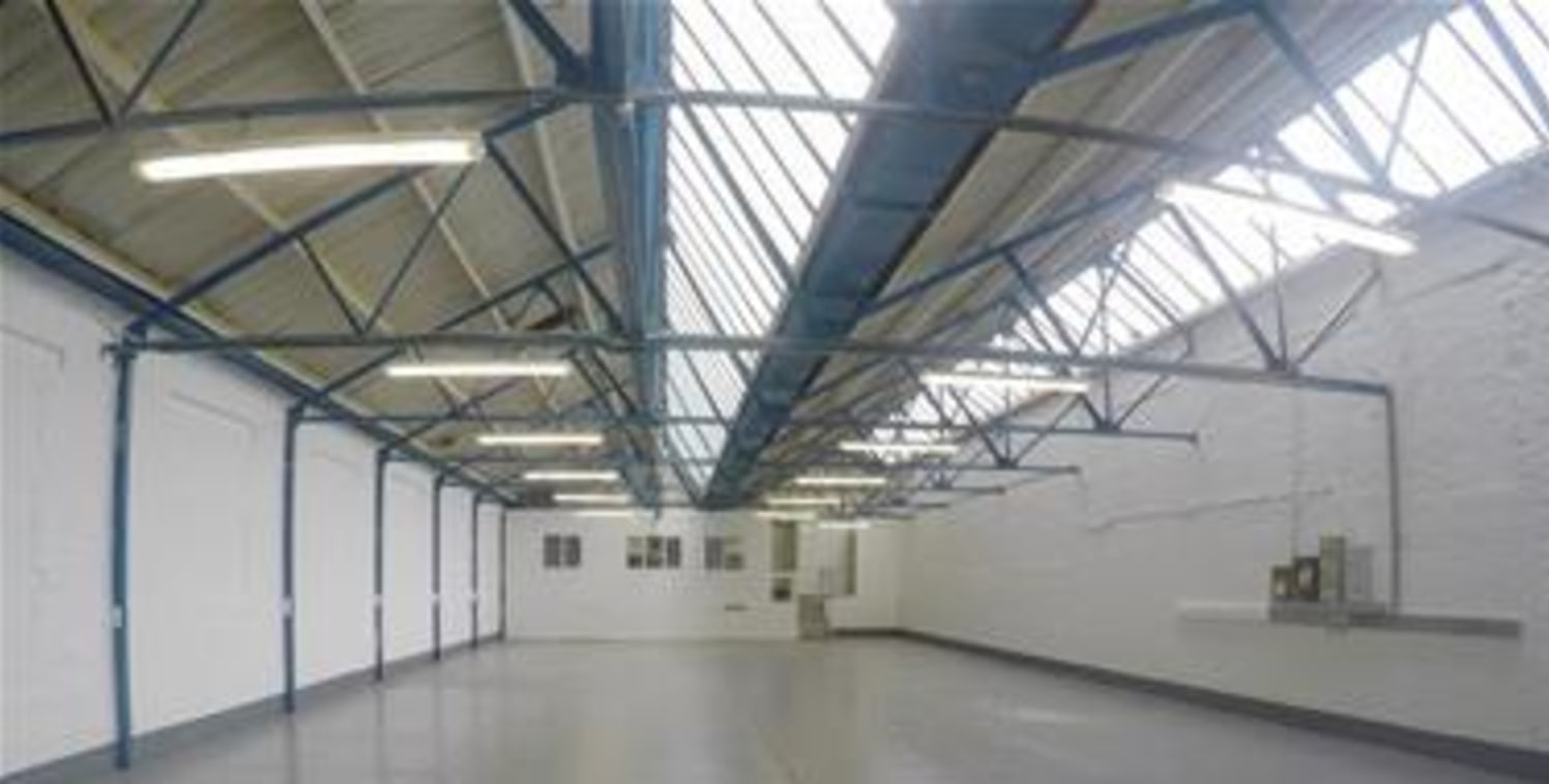 The premises comprise a steel truss warehouse/industrial unit of clear open plan configuration, benefiting from a roller shutter loading door serviced by a dedicated loading bay. Car parking is available on the estate....