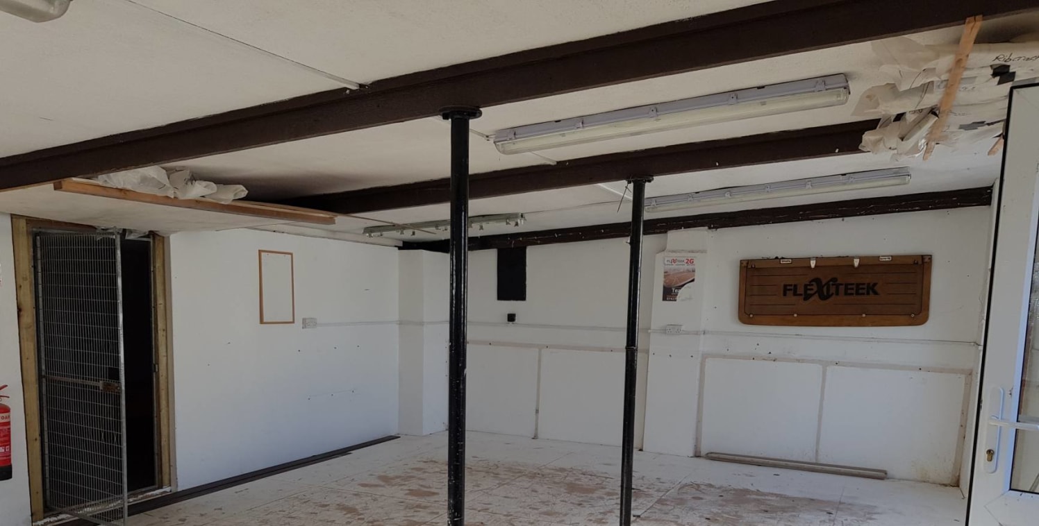 The premises comprise a single storey workshop/store with an open plan area and a rear store area. The unit is accessed via a personal front door and has a sloping ceiling down to a height of 2.1 meters....