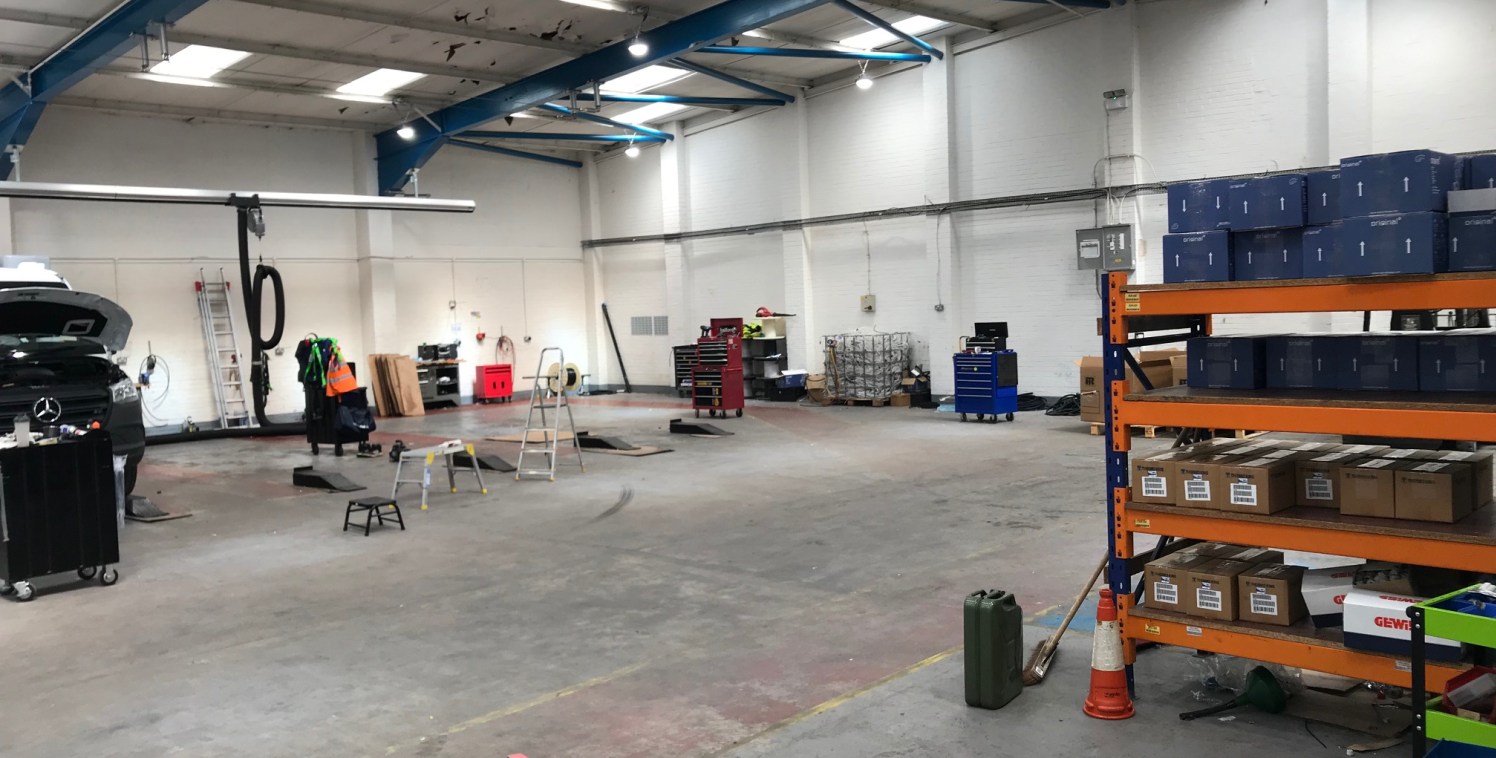 The property comprises a detached warehouse unit set on a self-contained, secure site. The unit is of a steel portal frame construction with a combination of brick and profile metal clad elevations under a pitched profile metal clad roof with 10% roo...