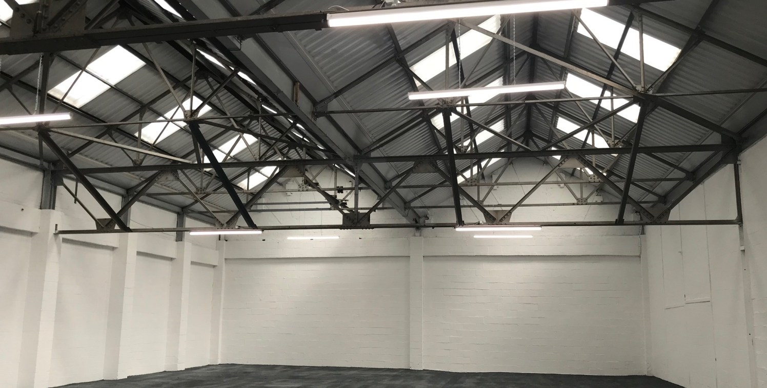 A modern single storey warehouse unit benefitting from high quality single storey offices, ladies and gents W/Cs and a single drive in level access...