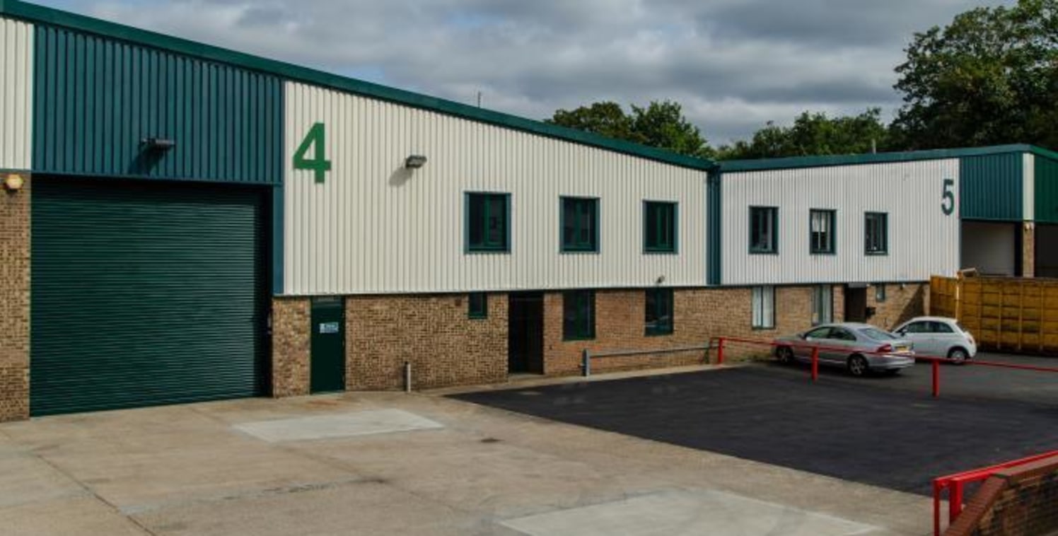 The property comprises an end of terrace warehouse unit with ancillary ground and first floor offices. The unit provides 4.75m clear internal eaves height, a single loading door, and translucent roof lights....