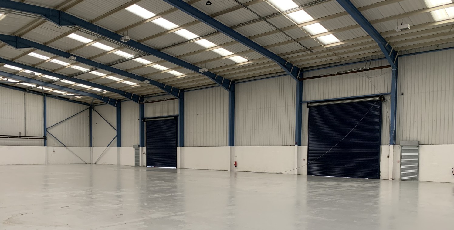 A modern portal frame warehouse/workshop unit incorporating two storey offices and having a yard to the rear which is surfaced in concrete hardstanding.

A separate car parking area surfaced in tarmacadam, is provided to the front of the property.

V...