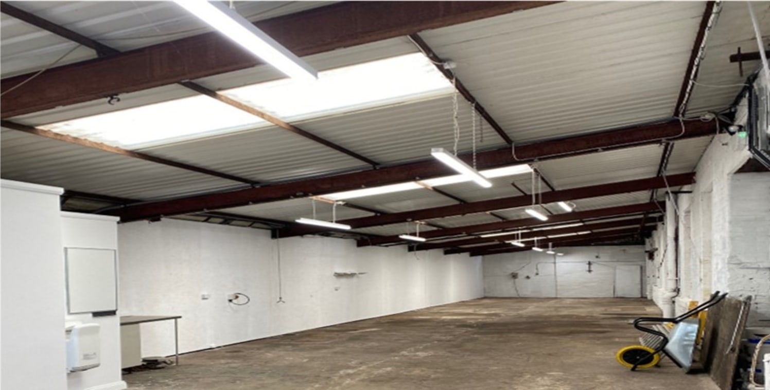 A complex of 12 individual single storey workshop units constructed of mainly brick elevations around steel frame finishes with predominantly asbestos sheet roof covering although some units have been overclad with profile aluminium sheeting.

The un...