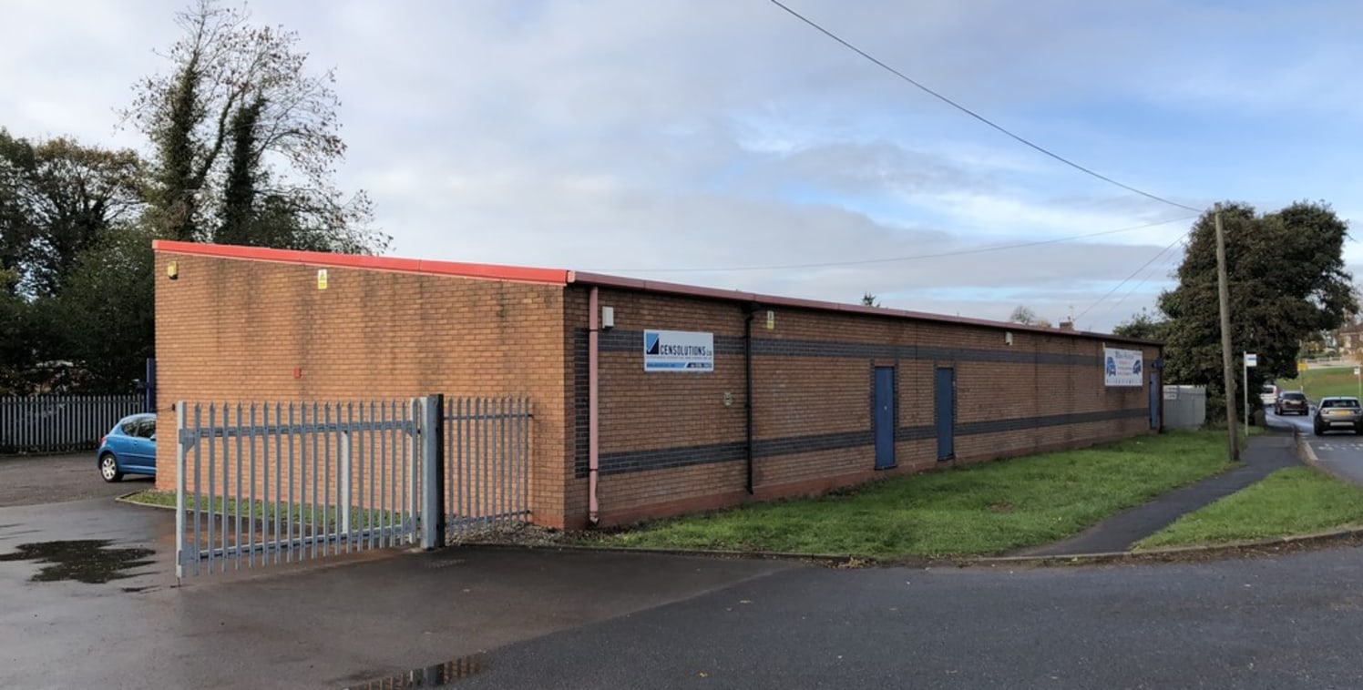 An end terraced single storey industrial unit standing within a secure yard with shared parking available.