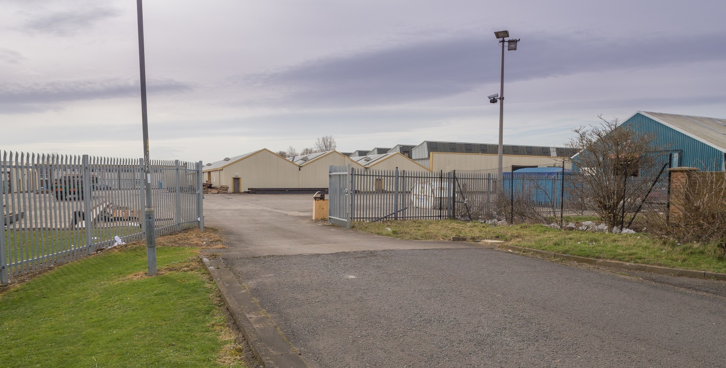 The property comprises a substantial industrial facility with extensive yard and parking areas, and adjoining offices. To the rear there is a further area of compound and/or development land. The building has been subdivided to provide a number of in...