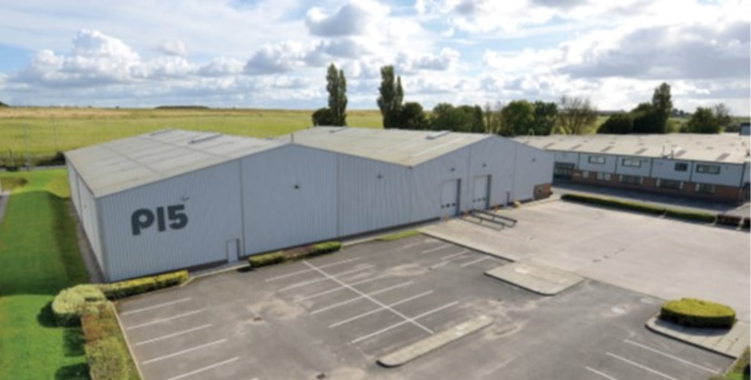 Steel portal frame construction. 2 bay interconnecting warehouse. 6.5m to eaves, 6m to underside haunch. Ground floor offices. High bay sodium box lighting. 2 no. drive-in loading doors. Mezzanine flooor. Suspended warm air blower heaters. Generous y...