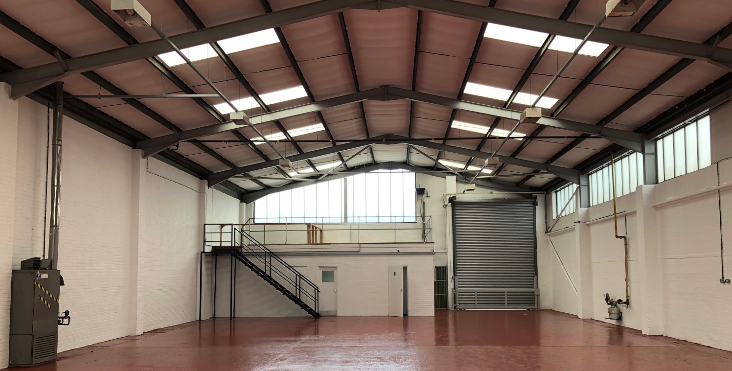 The property comprises a steel portal frame construction with part brick built/part glazed elevations and a pitched corrugated asbestos roof incorporating translucent light panels. Eaves height is approximately 5....