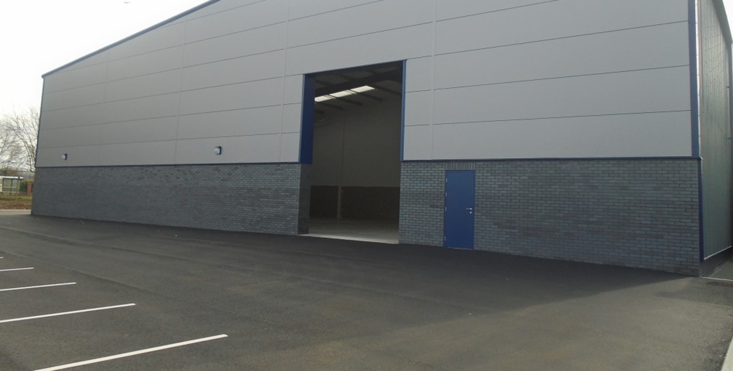 The property forms part of a terrace of five industrial units completed in 2018 and located close to the junction with Haslam's Lane.

Each building is of steel portal frame construction with facing brick and composite panel elevations and feature pi...