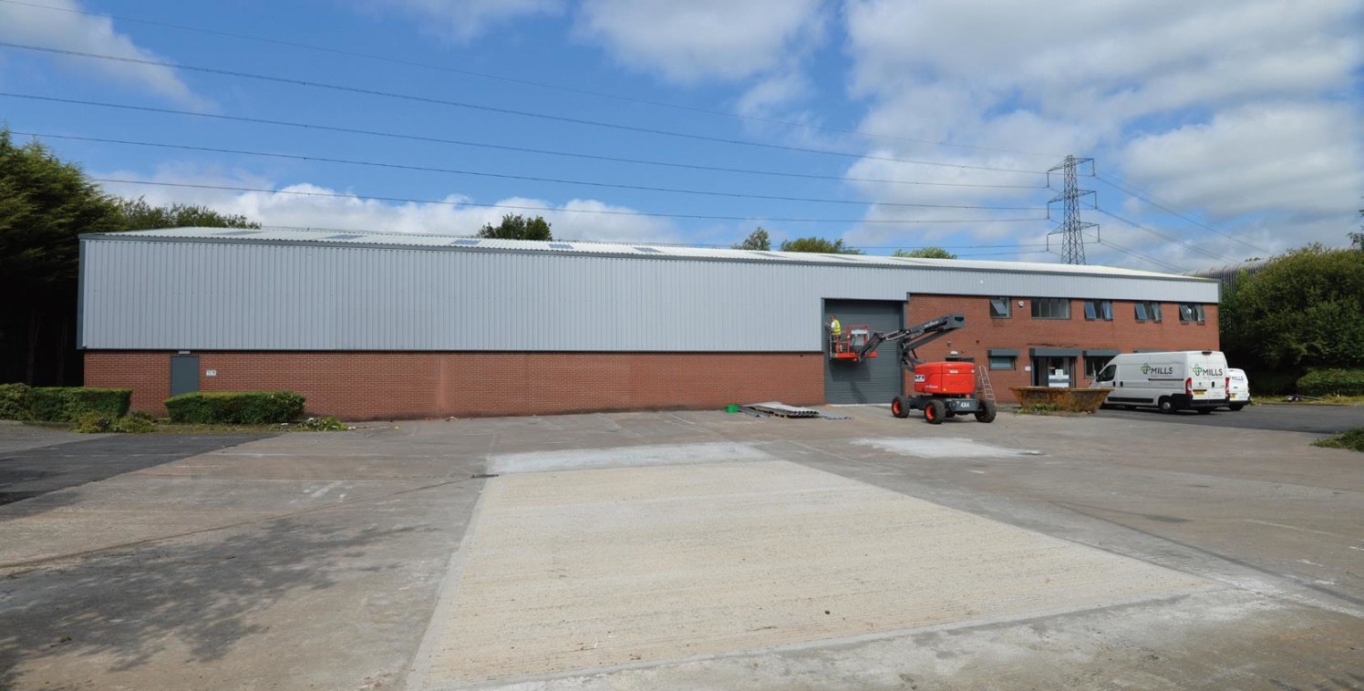 Steel portal frame construction. Profile sheet clad elevations. 6m eaves. Two electric roller shutter loading doors. Two storey offices. Securely fenced and gated yard. LED lighting throughout. 16 marked parking spaces.