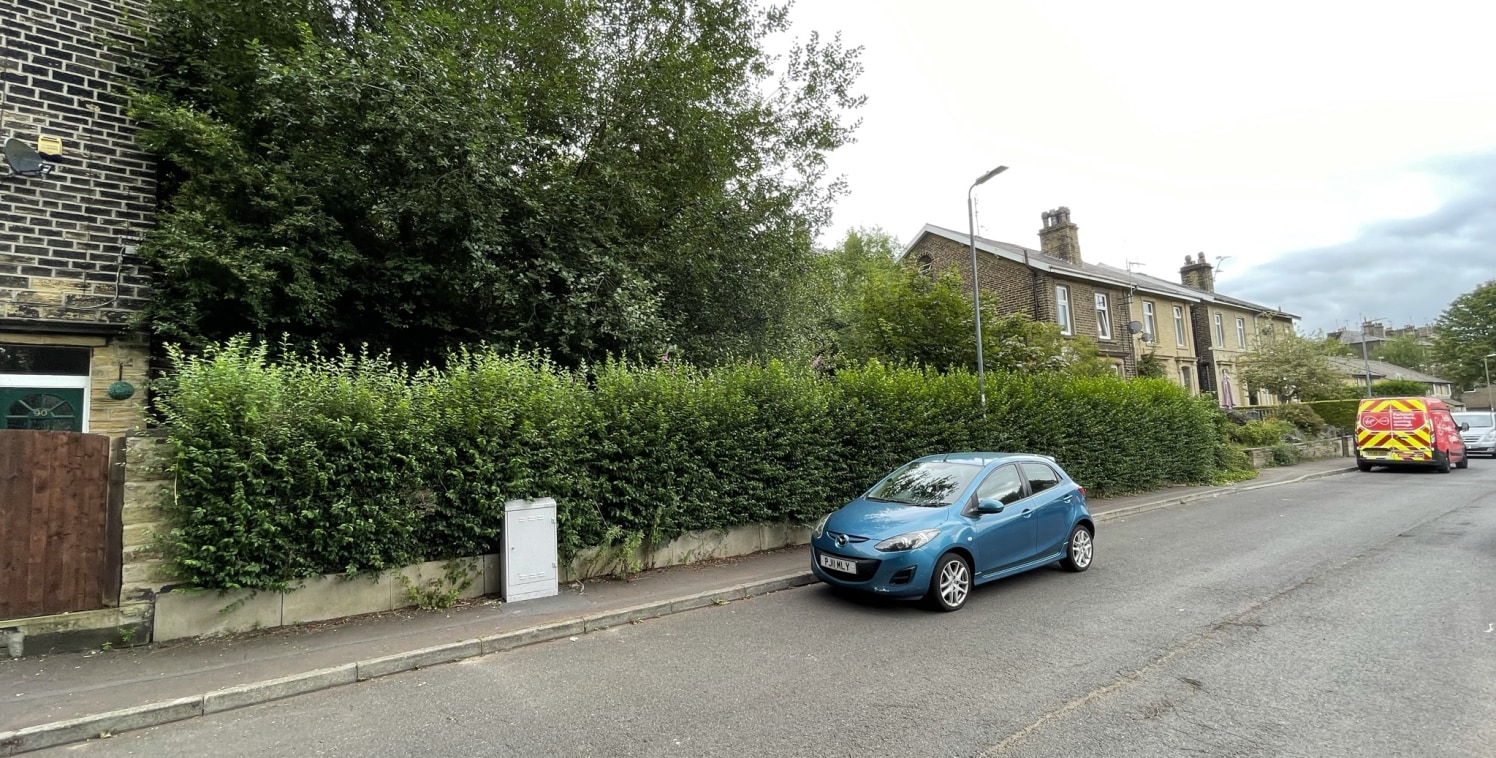 The land is situated in a residential area of Sowerby Bridge with access from both Hollins Lane and Industrial Road due to the sloping topography of the site. The parcel of land is rectangular in shape and gently slopes roughly from North to South. T...