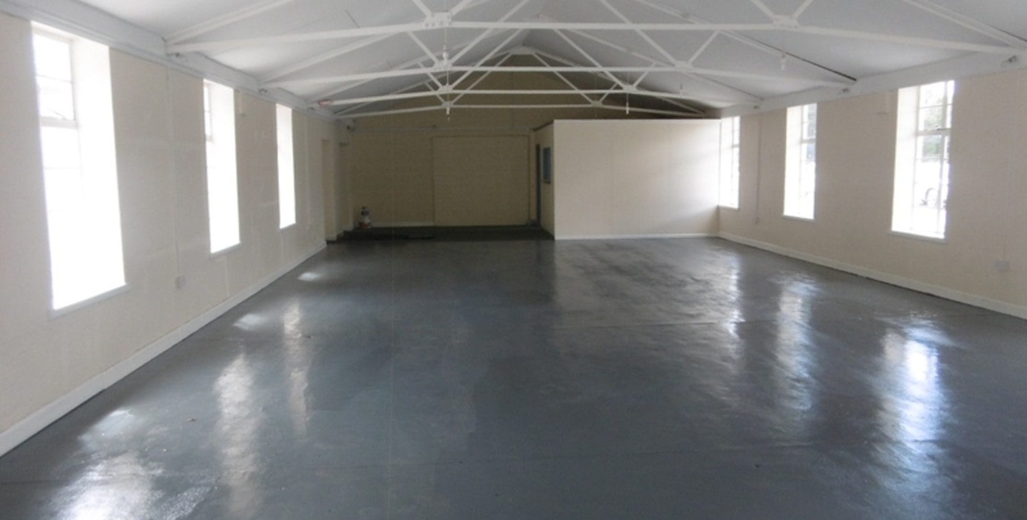 The property adjoins RAF Cosford and comprises an open span commercial/ industrial premises with extensive onsite communal parking. The unit is mainly open plan with single internal office, roller shutter door vehicular entrance and an internal eaves...