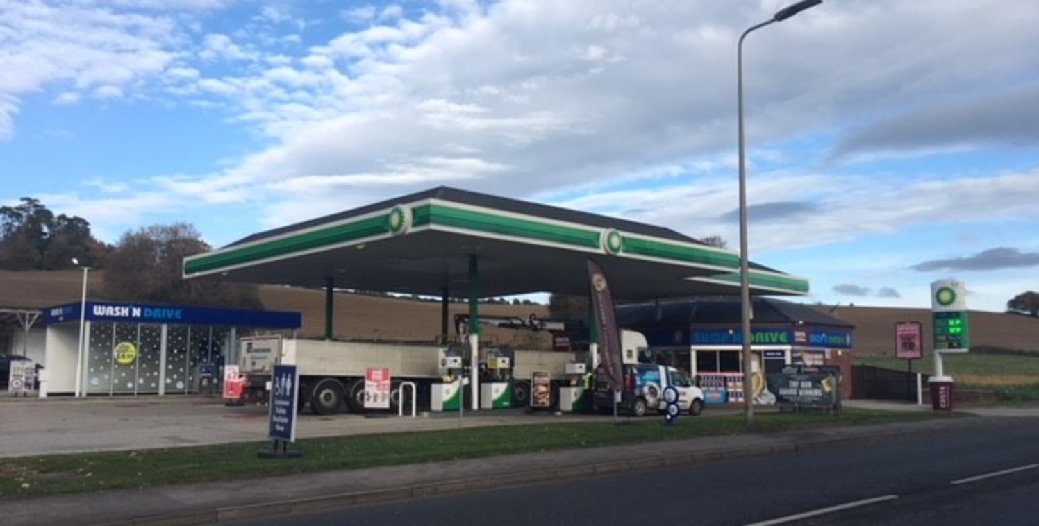 The property comprises a prominent Petrol Station with Forecourt sales, shop, car wash and separate workshop buildings. 

The Petrol Station and workshop sit on a site of 2.65 acres.

Both elements of the site are currently let, the Petrol Station wi...