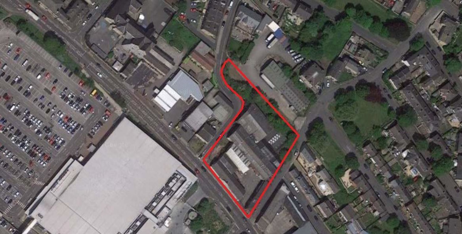 The site is largely rectangular although protruding to the north west corner, and is situated on a site which slopes upward from Bradford Road towards the rear of the site. The site is presently occupied by Victoria Works.