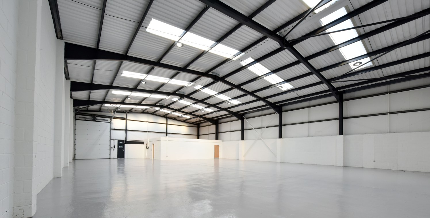 The property comprises a semi-detached, steel portal framed industrial / trade counter unit.