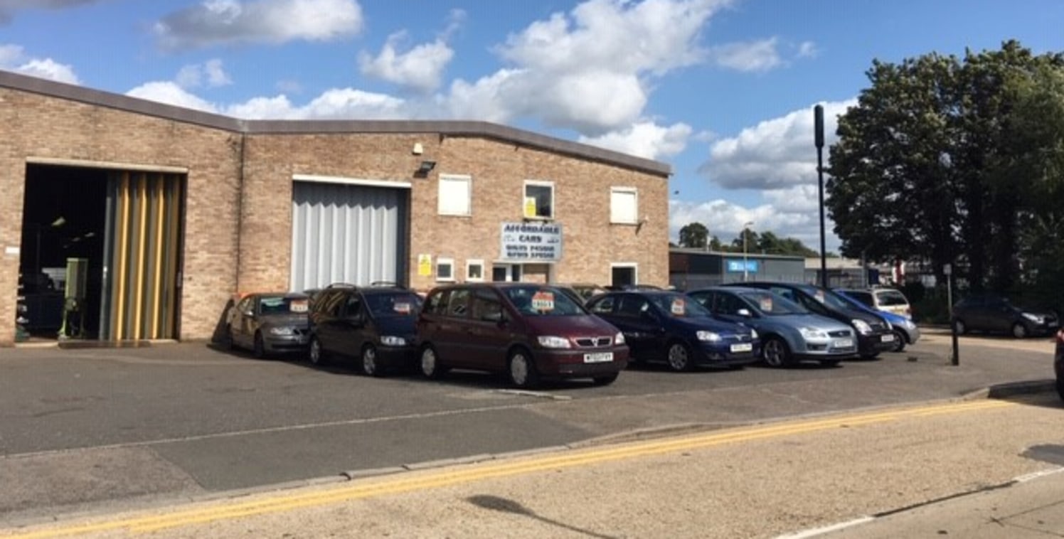 This prominent trade counter building comprise a portal frame with brick elevations and clad roof.

Internally the property includes open workshop with ground and first floor offices, WC and kitchen facilities.

Outside there is a forecourt with park...
