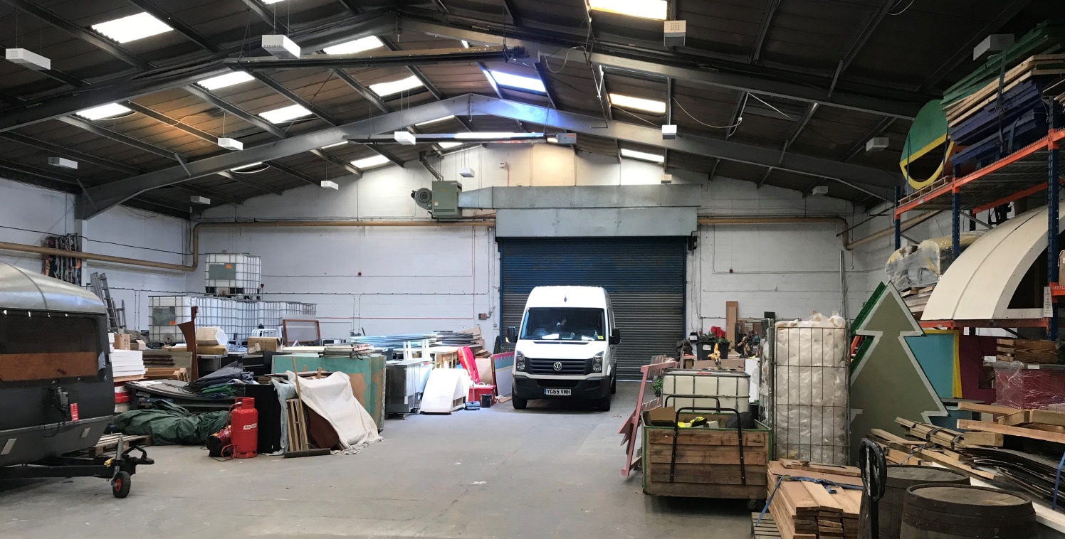 The property comprises a semi-detached industrial unit of traditional steel portal frame construction underneath a pitched roof. The unit has a concrete apron fronting the access road with space for external storage/vehicle parking. The unit is acces...