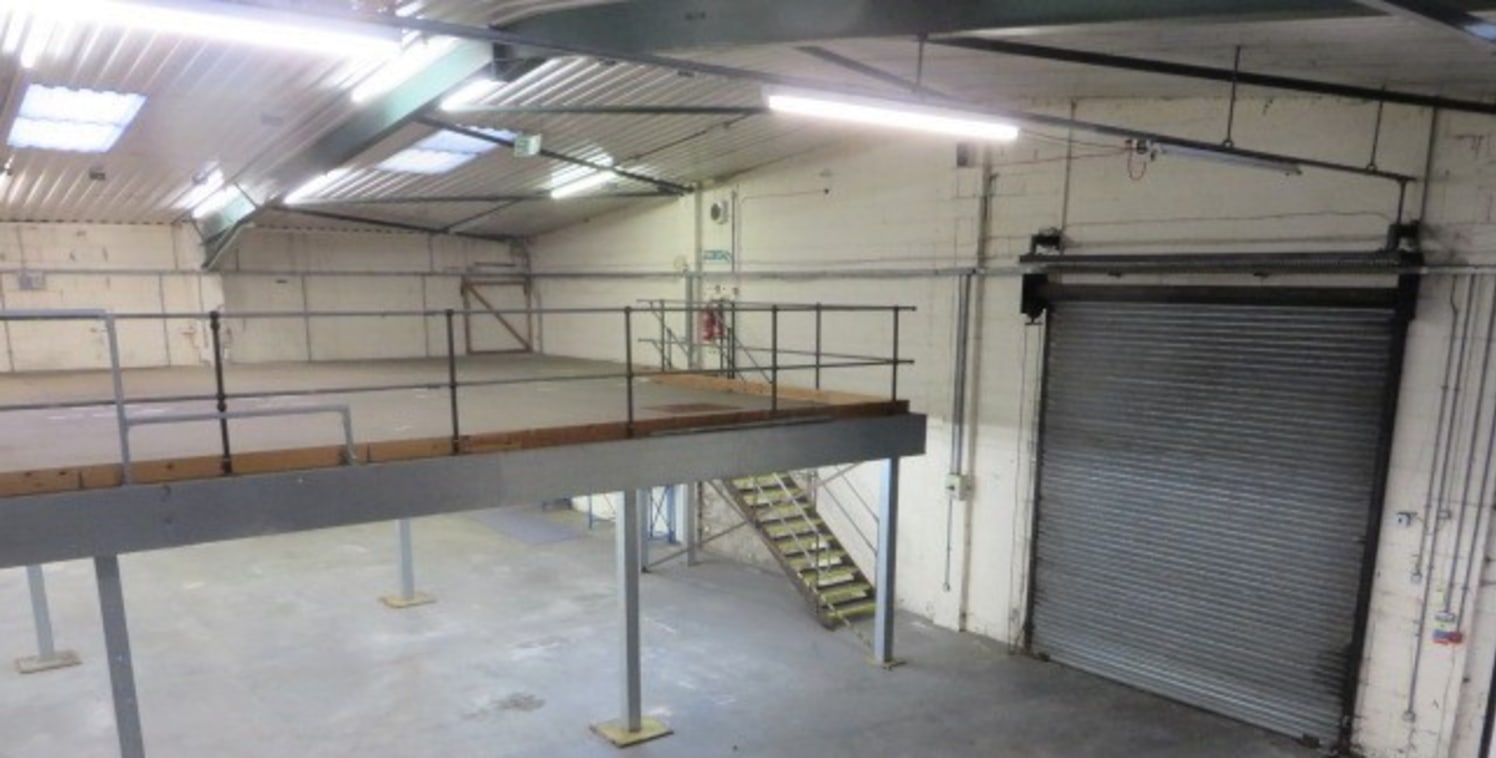 Semi-detached steel portal frame unit.<br><br>2 no. roll shutter doors. Clear eaves 4.5m.<br><br>Much of warehouse currently has purpose built mezzanine over extensive parking adjacent.<br><br>Ground Floor: 11,622 sq ft<br>First Floor: 9,951 sq ft<br...