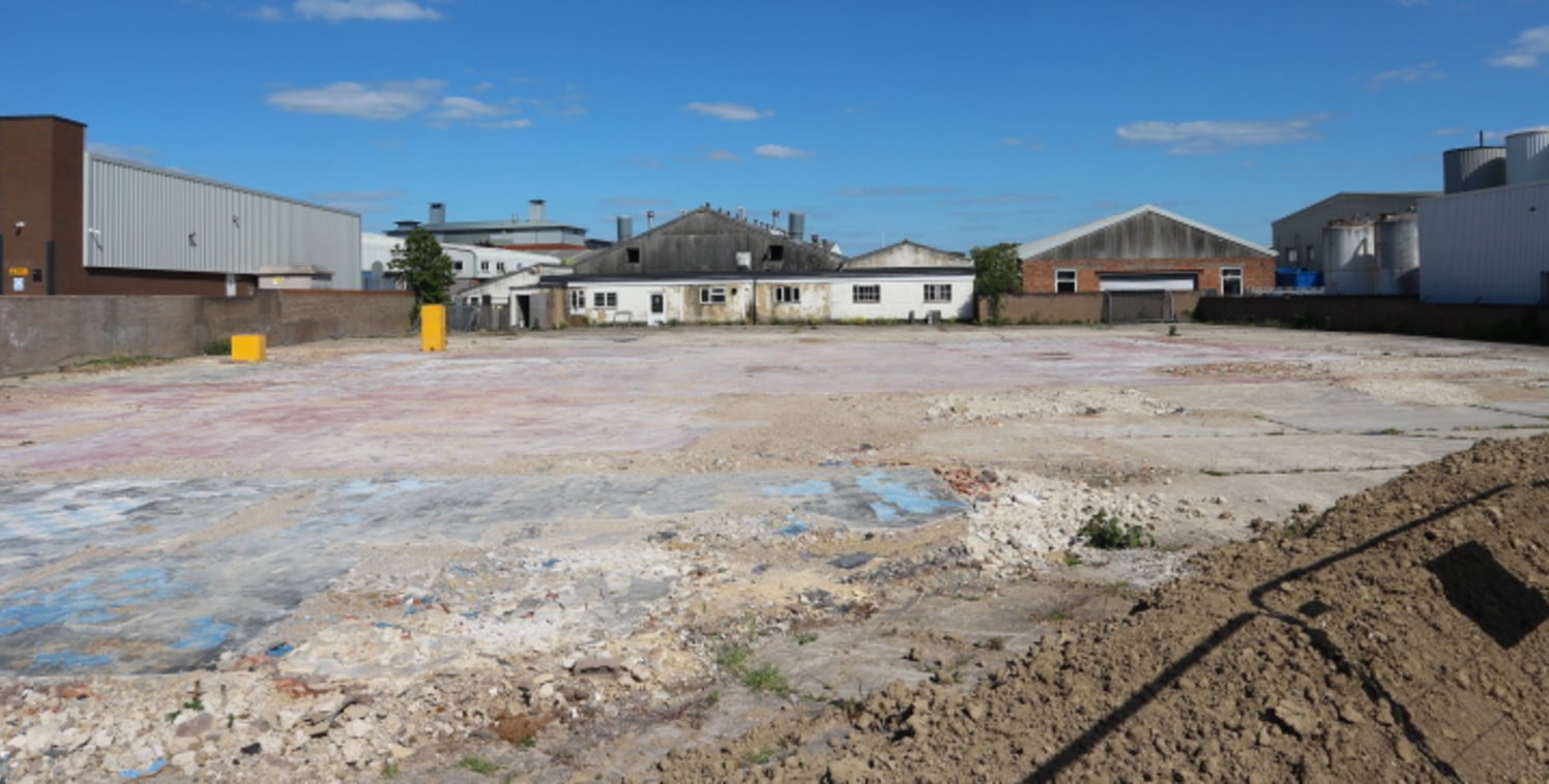 The premises comprise a large cleared and predominantly hard standing secure storage yard accessed via large entrance gates.