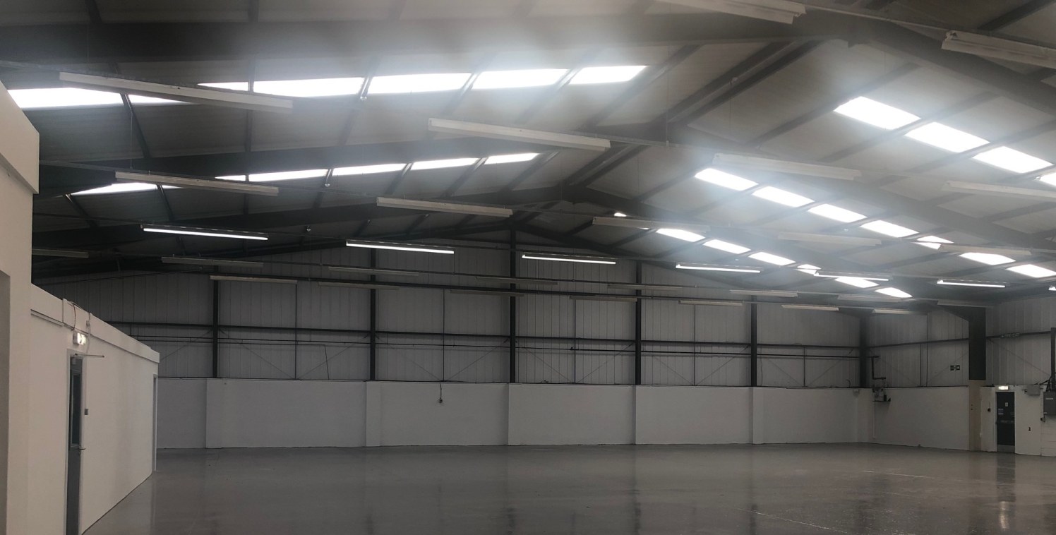 The property comprises a detached industrial/ warehouse unit of steel portal frame construction. There is a small office fronting the property together with toilet facilities. 

The property benefits from the following specifications: 

Minimum eaves...