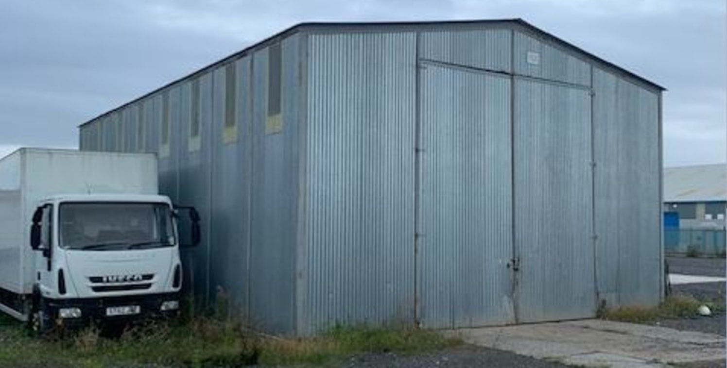 A secure yard extending to approximately 0.75 Acres with a modular office and basic storage building on site.

The modular office provides WC and kitchen amenities.

The site is bounded by a steel palisade fence and concrete panel fence and is access...