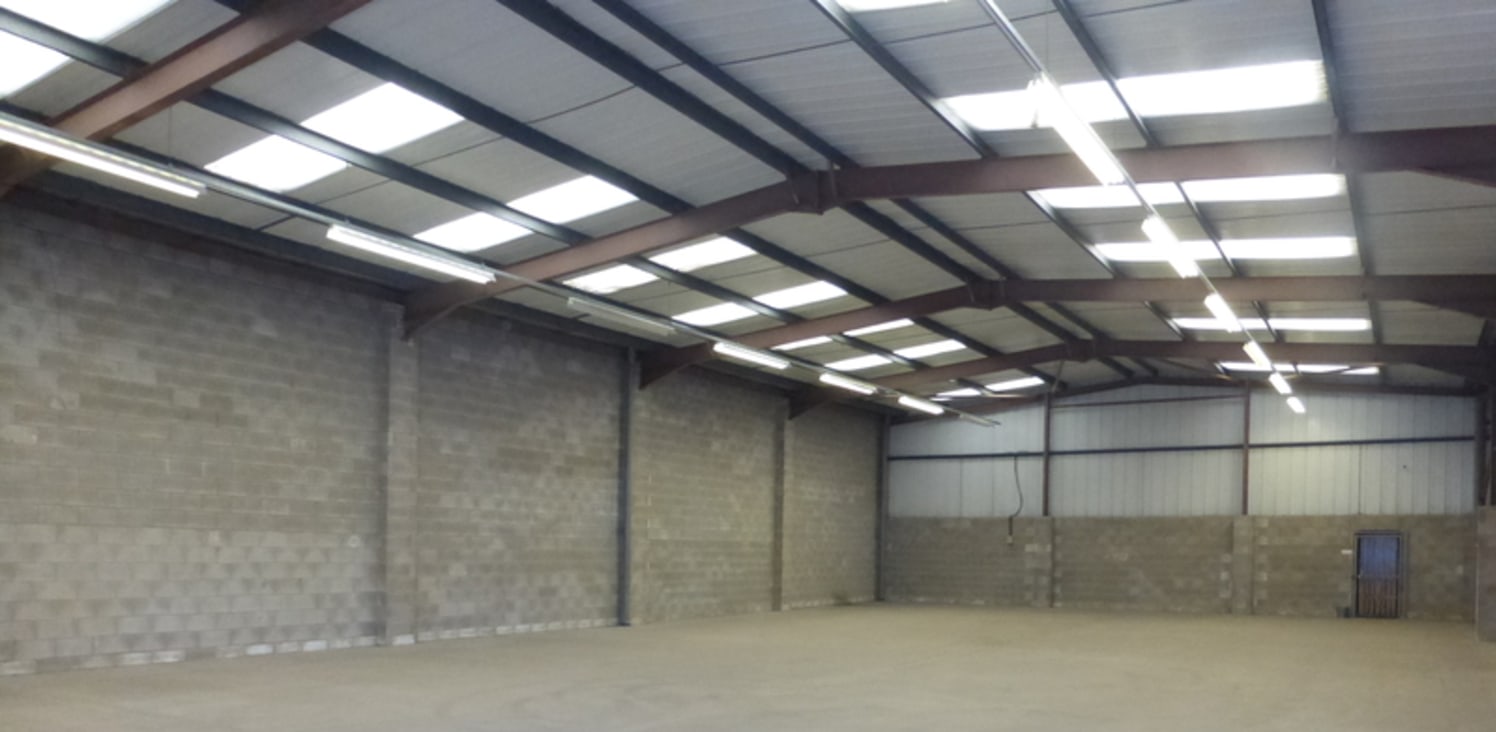 The unit is an end single terrace bay industrial unit of steel portal frame construction with brick infill and part brick an profile metal sheet cladding, with a pitched lined roof incorporating translucent lights. The unit benefits from forecourt ca...