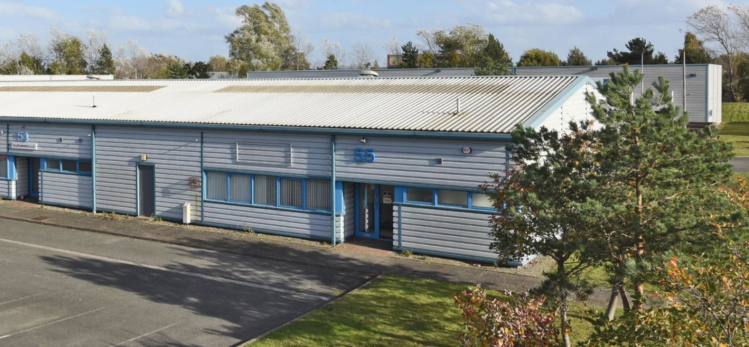 Portal frame construction. Ground level access door. 5m clear working height. Single storey office/staff accommodation. Car parking. Rear service yard.