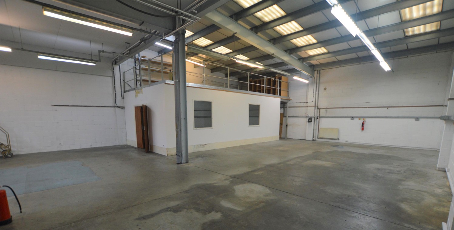 The property comprises an end of terrace industrial unit with profile clad elevations under a pitched roof. The ground floor warehouse benefits from a roller shutter door, a reception / entrance area, kitchen, toilet facilities and an office/studio s...