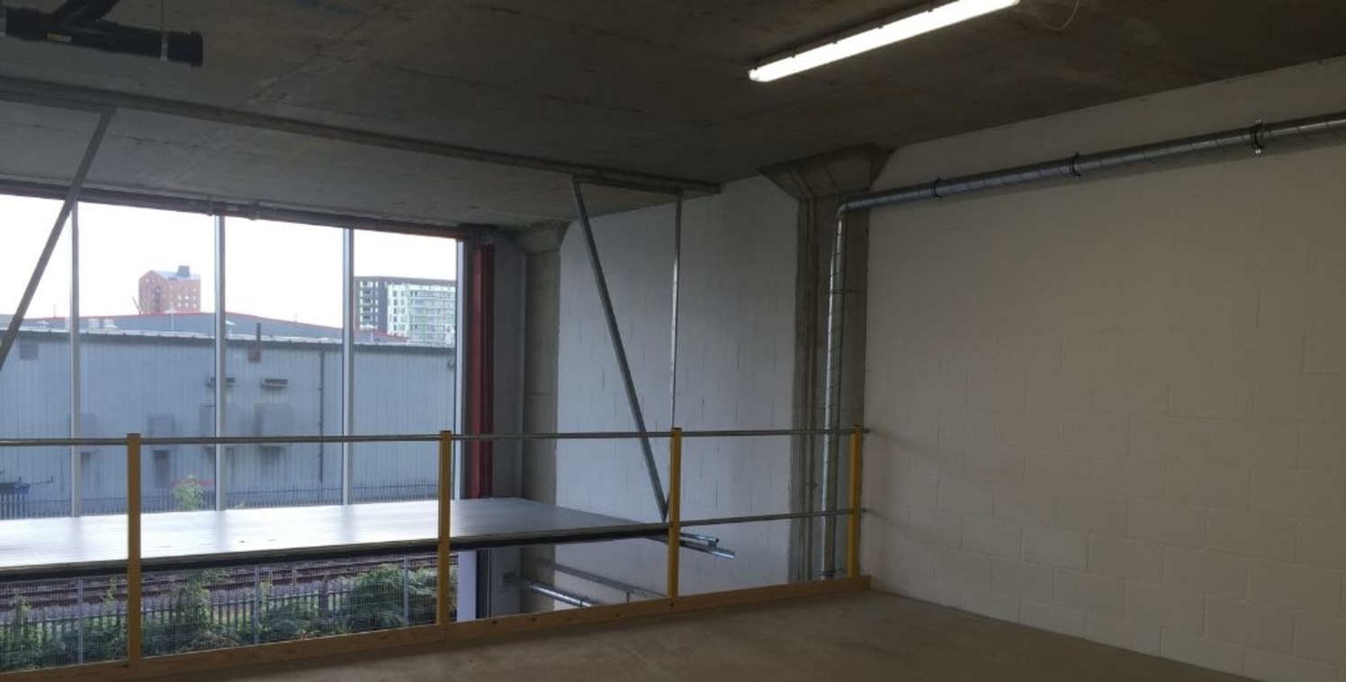 Self-contained studio/office unit arranged as open plan accommodation over ground floor and mezzanine levels. The unit has been finished to a good decorative order with white wash walls, painted concrete floor, recessed lighting and 3 phase power as...