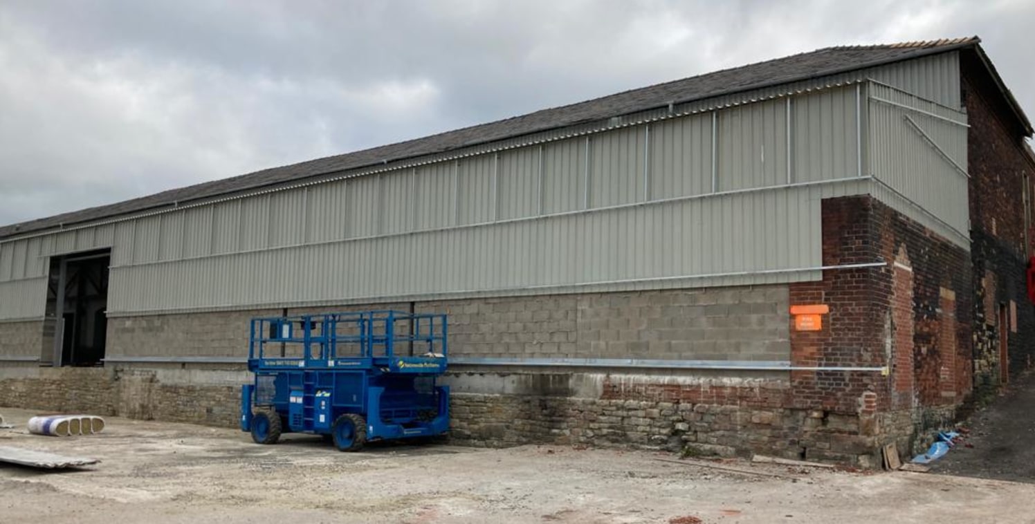 Unit 9 is accessed to the rear of the site and would be suitable for light manufacturing, storage and distribution. Access is via two electric roller shutter doors. 

The unit has a concrete floor, partially under a pitched slate roof, and a new stee...